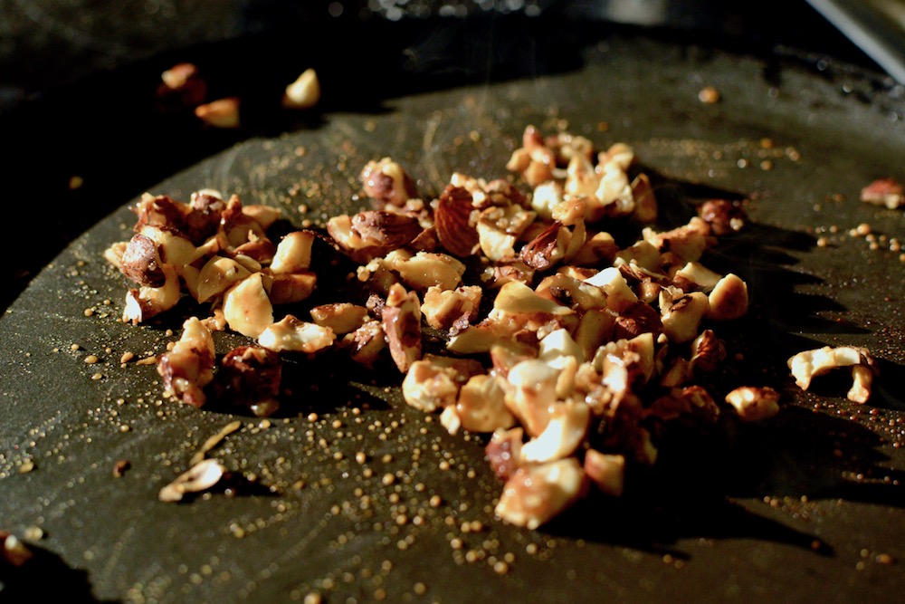 Hazelnuts with melted brown sugar starting to caramelise