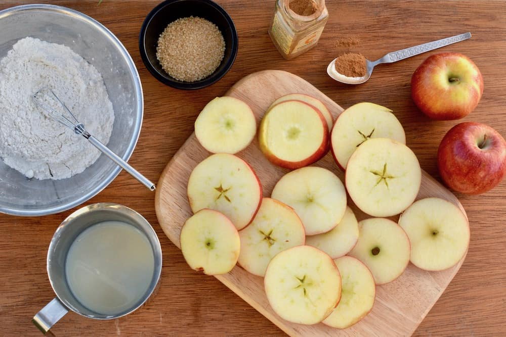 Ingredients for vegan apple fritters - flour, soy milk. apple, sugar and cinnamon