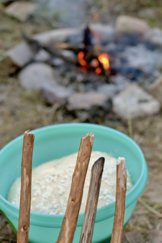 Four sticks with bark removed ready for baking bread on