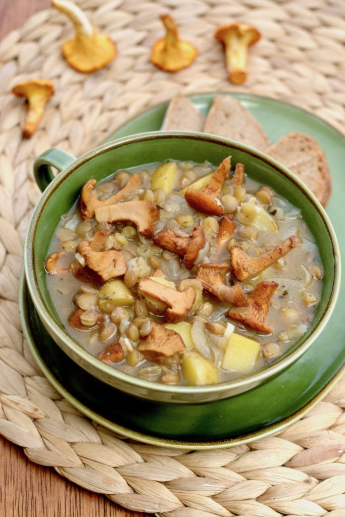 A lentil stew with cooked golden brown chanterelles on top