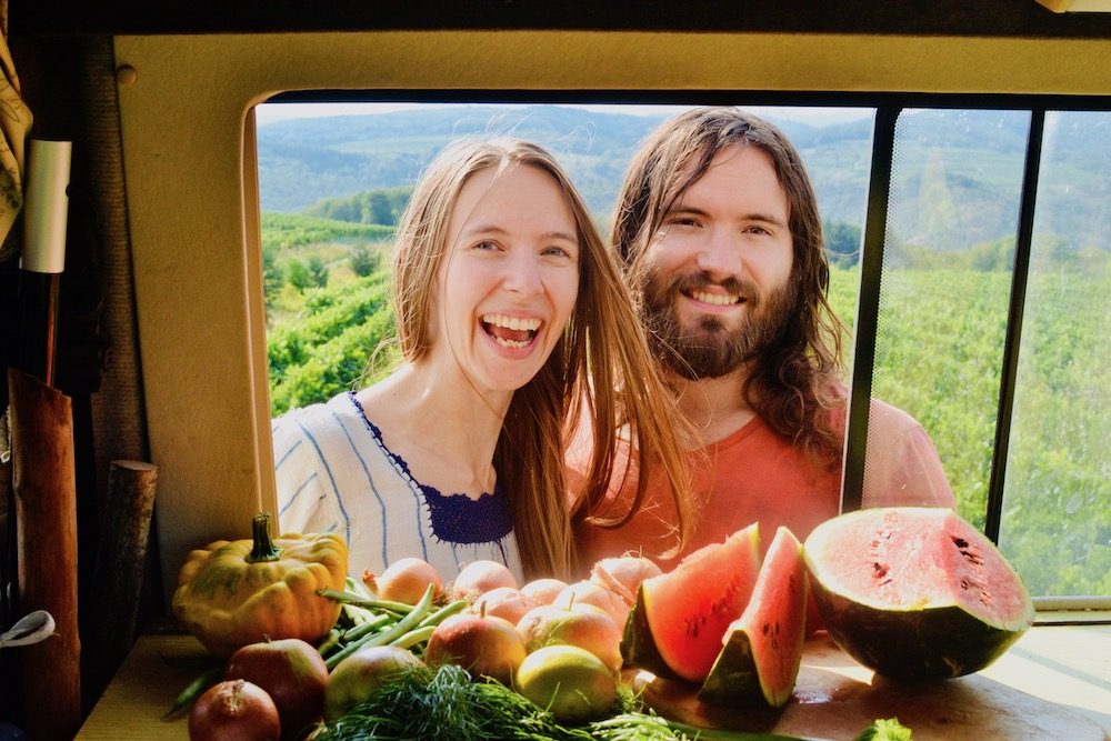 Sophie and Paul with fresh produce in the campervan