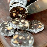 Cutting slices of chocolate salami