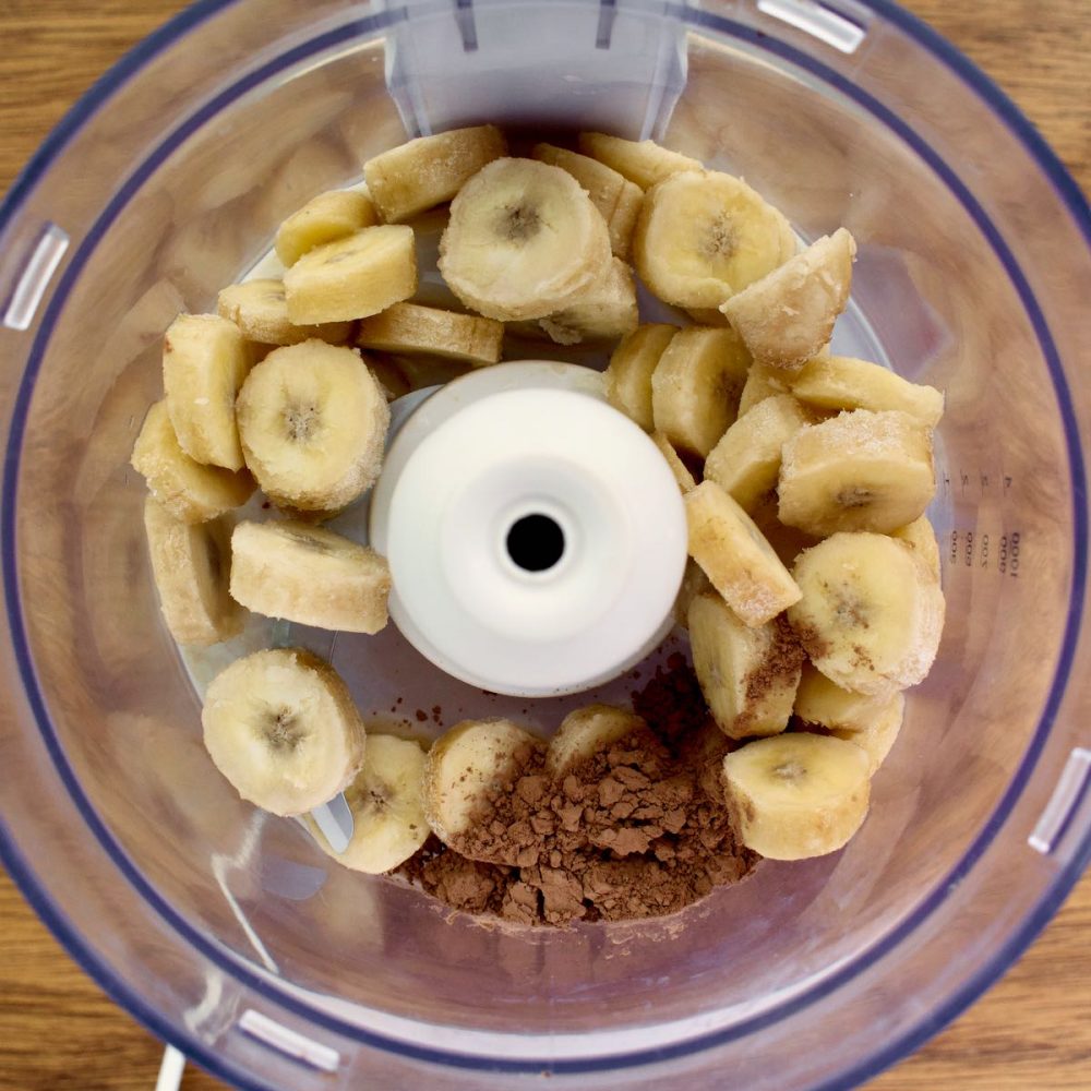 Banana slices, cocoa powder and soy milk in a blender