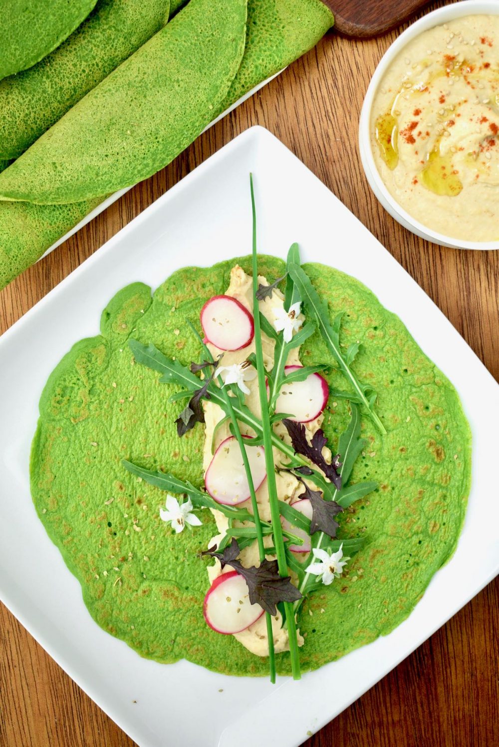 The finished spinach pancake is filled with hummus, radishes, rocket and herbs. 
