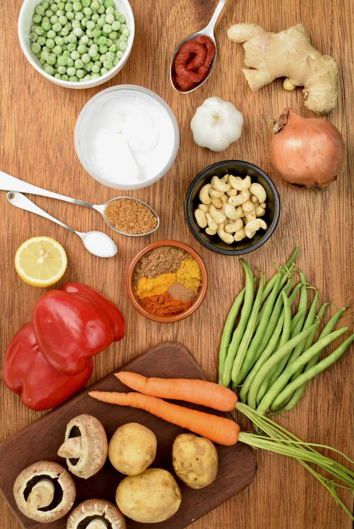 All the ingredinets for the vegan korma laid out on a board.