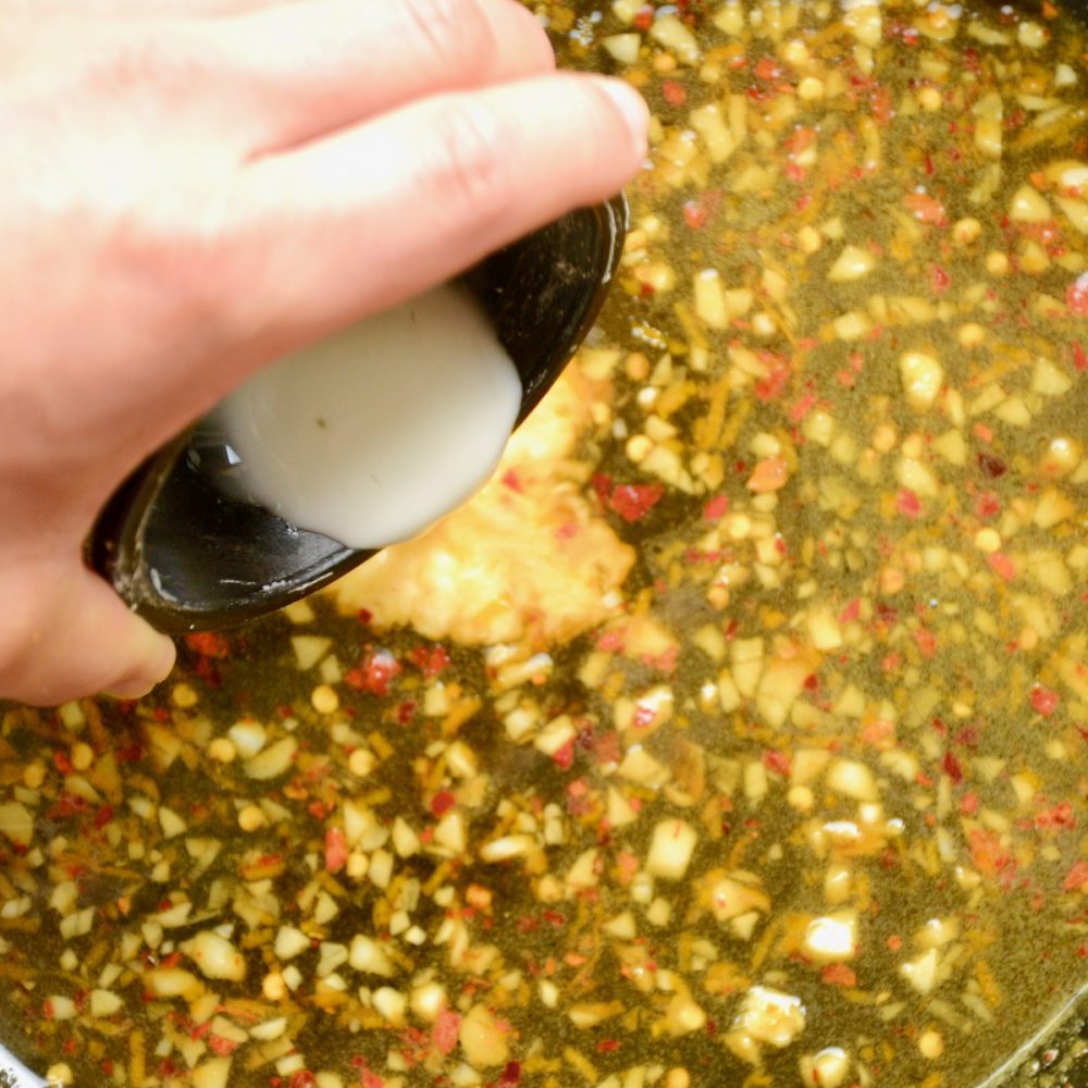 To thicken the sauce, a slurry of cornstarch and water is stirred in.