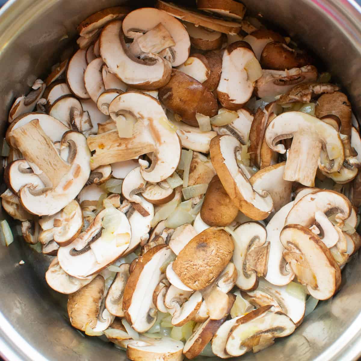 Sliced chestnut mushrooms in a pan.