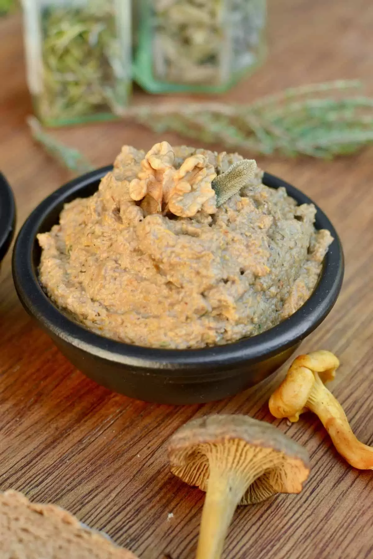 Light brown coloured mushroom pate topped with a walnut and sage leaf.