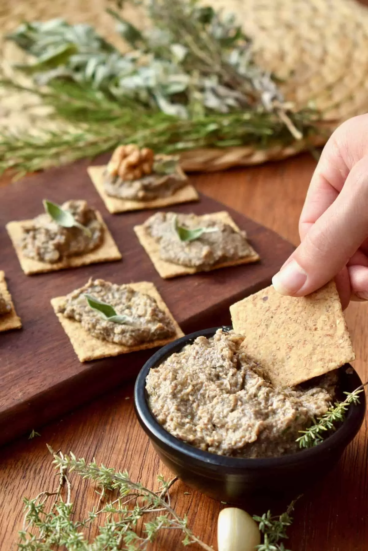 Dipping a cracker into the vegan pate.