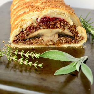 A wellington with mushroom filling. The puff pastry, the cooked filling and whole mushrooms offer a lot of different textures in this dish.