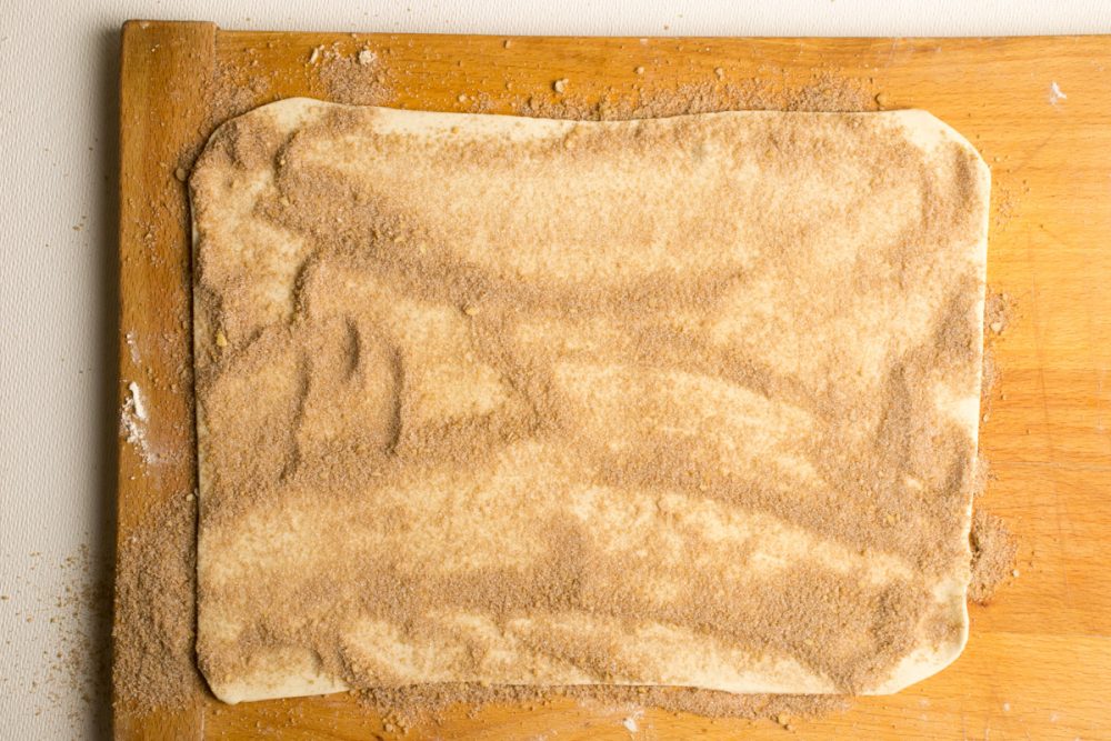 The puff pastry sheet is covered with cinnamon sugar.