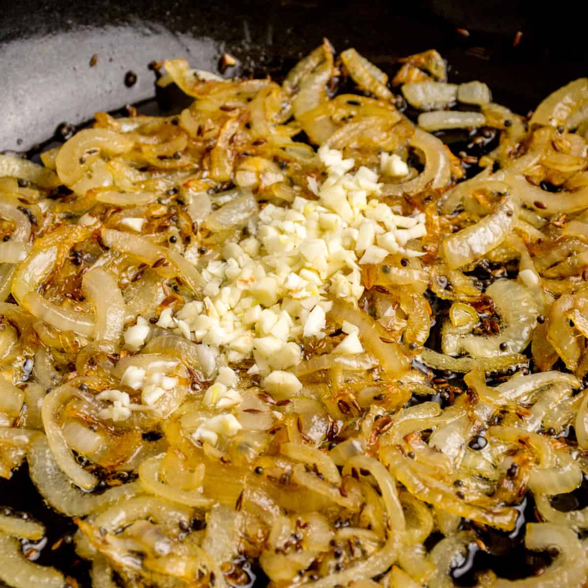 The onion is know golden brown as the chopped garlic is added.