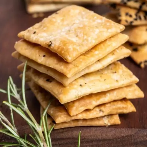 A stack of homemade square vegan crackers.