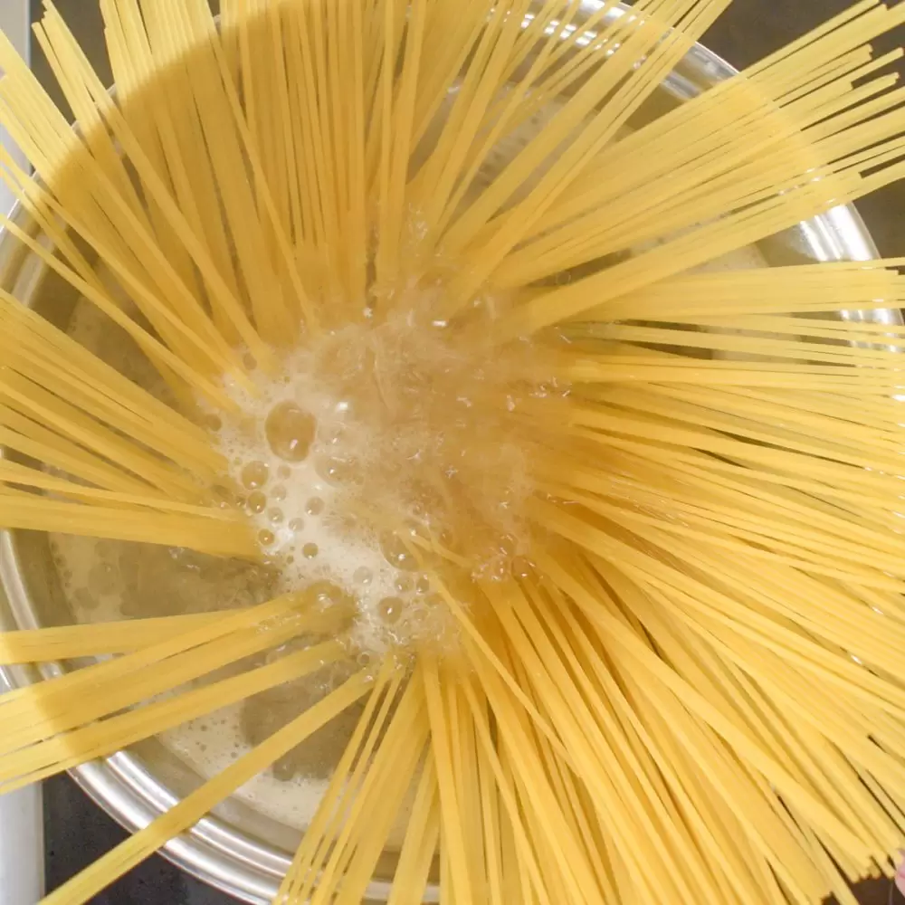 Boiling spaghetti in a saucepan.