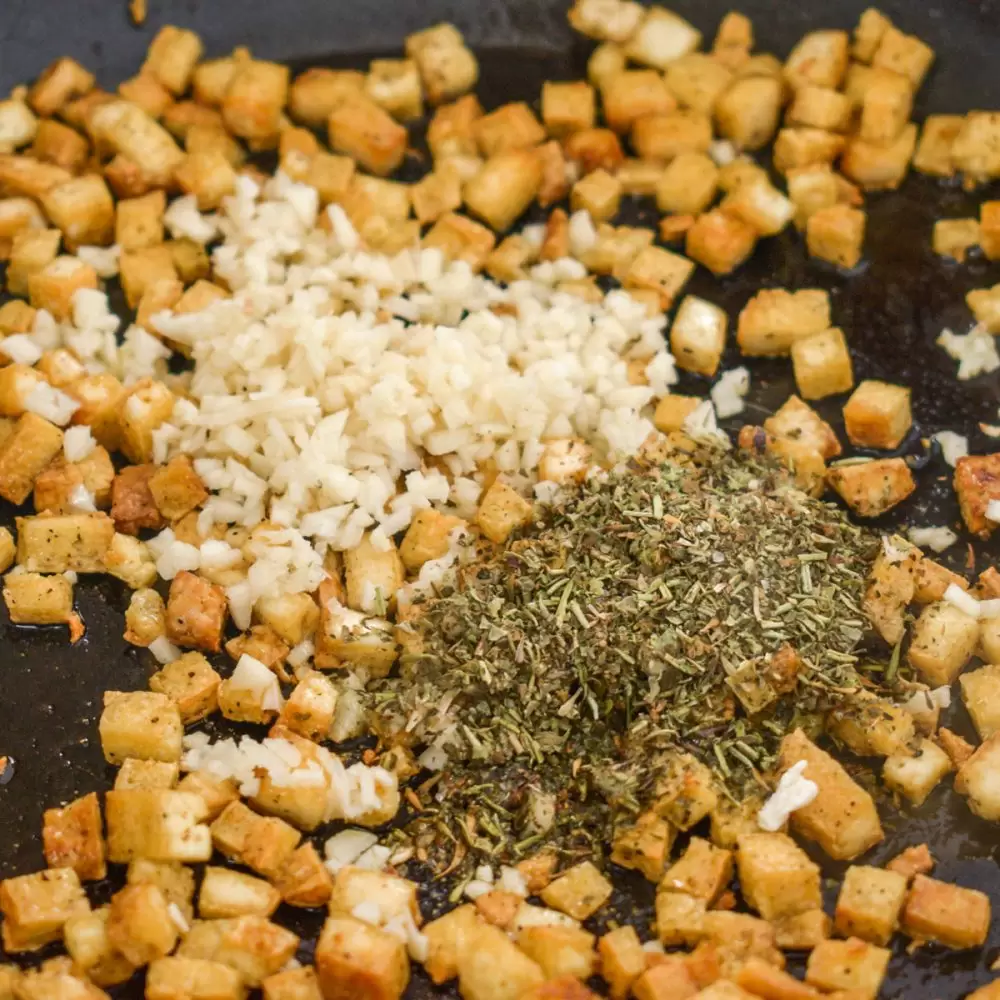 Dried herbs and garlic are added to the tofu.