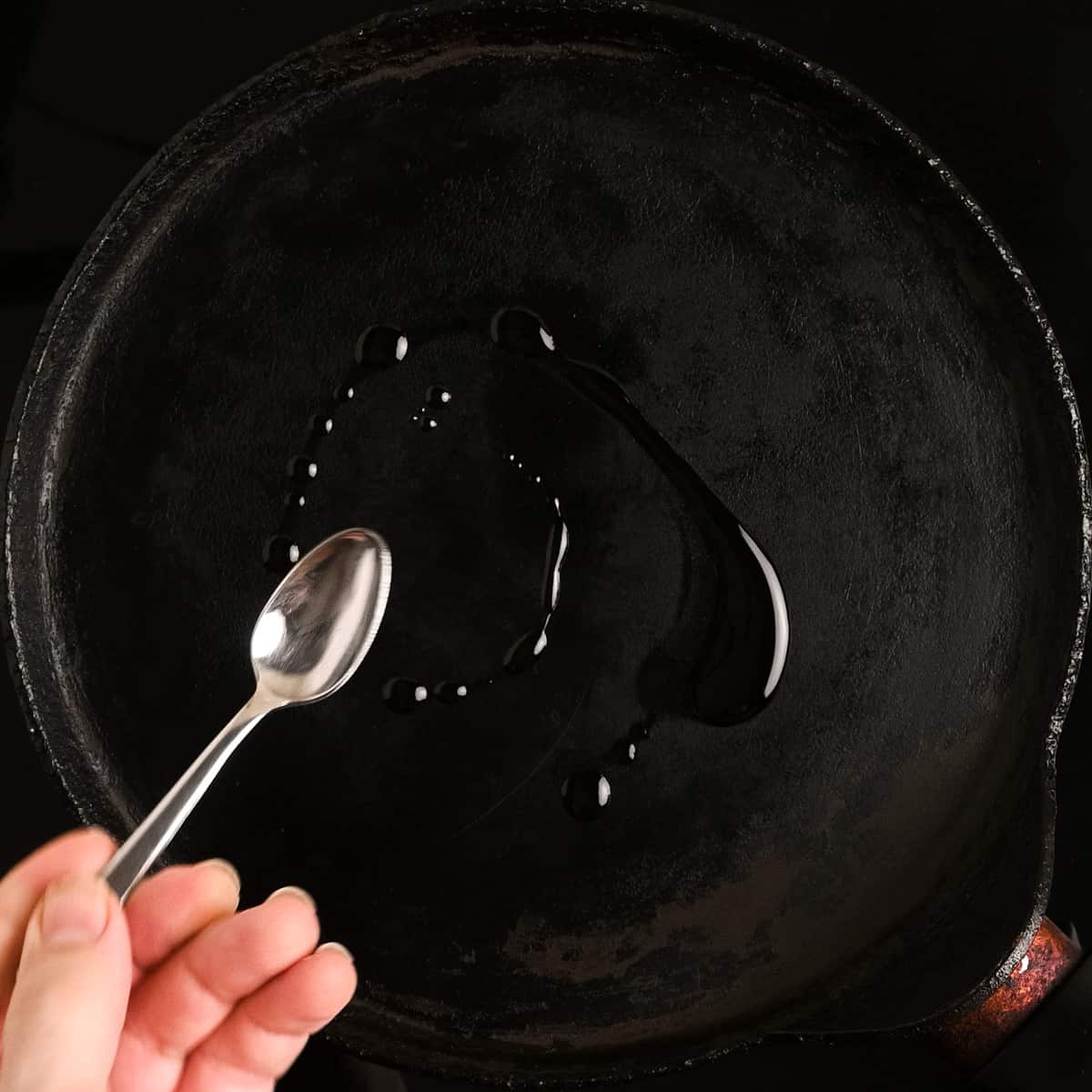 Heating up a crepe pan with a small spoonful of oil.