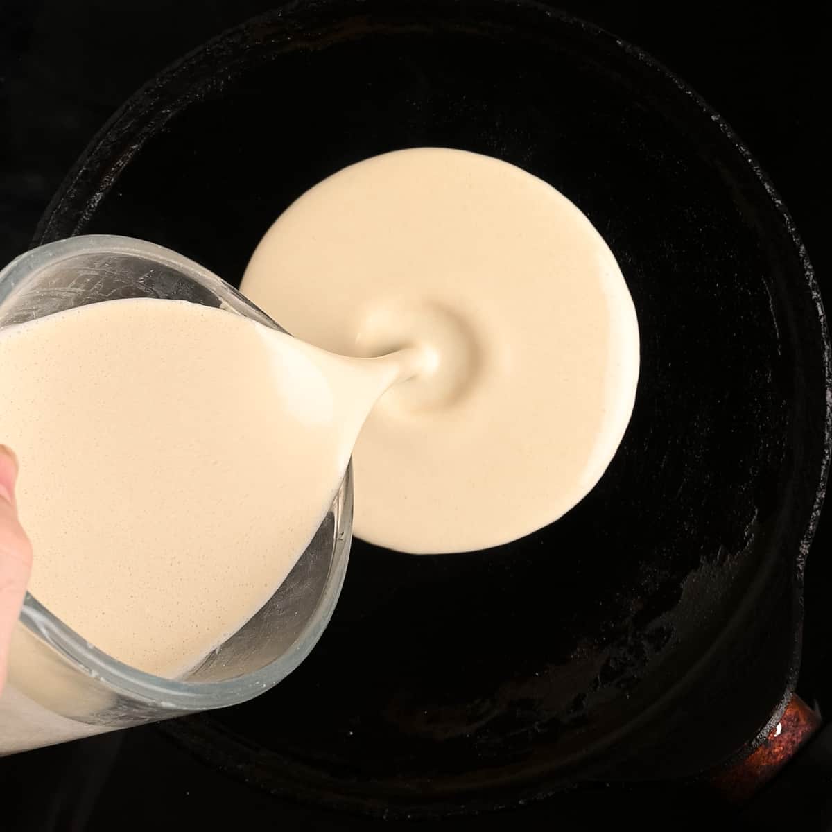 Pouring the batter into the middle of the pan.