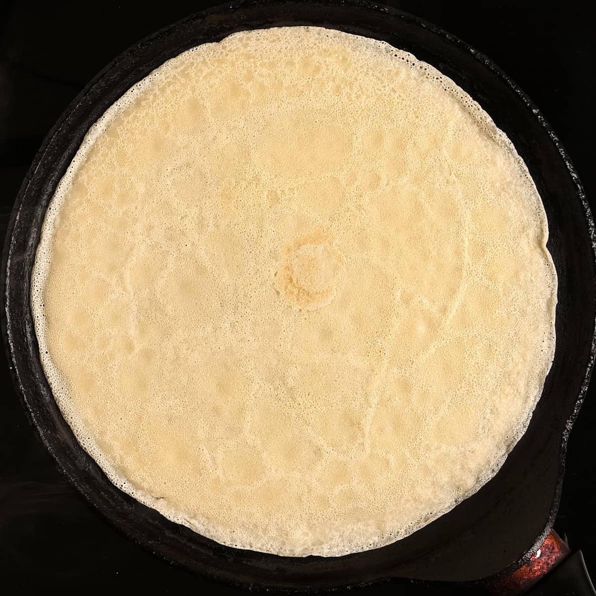 A cooked crepe on a pan.