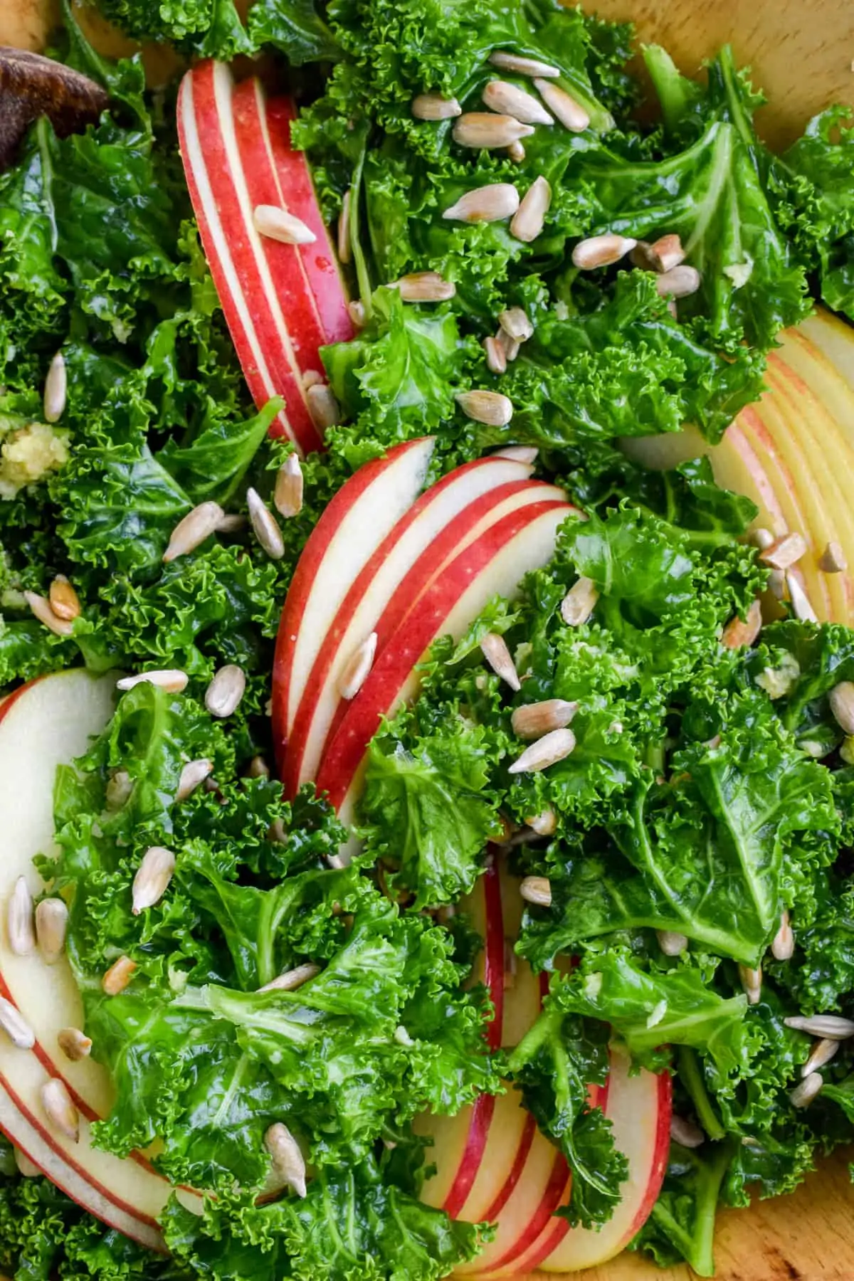 Slices of Braeburn apple are fanned and arranged on top of the massaged kale.