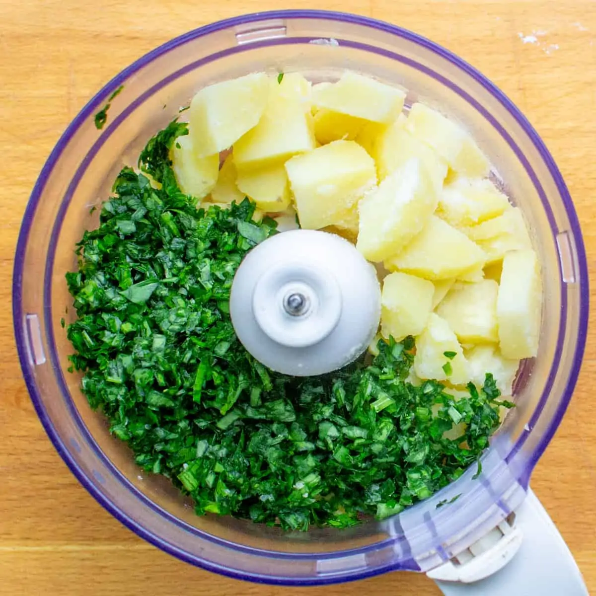 Potatoes and wild garlic in a food processor.