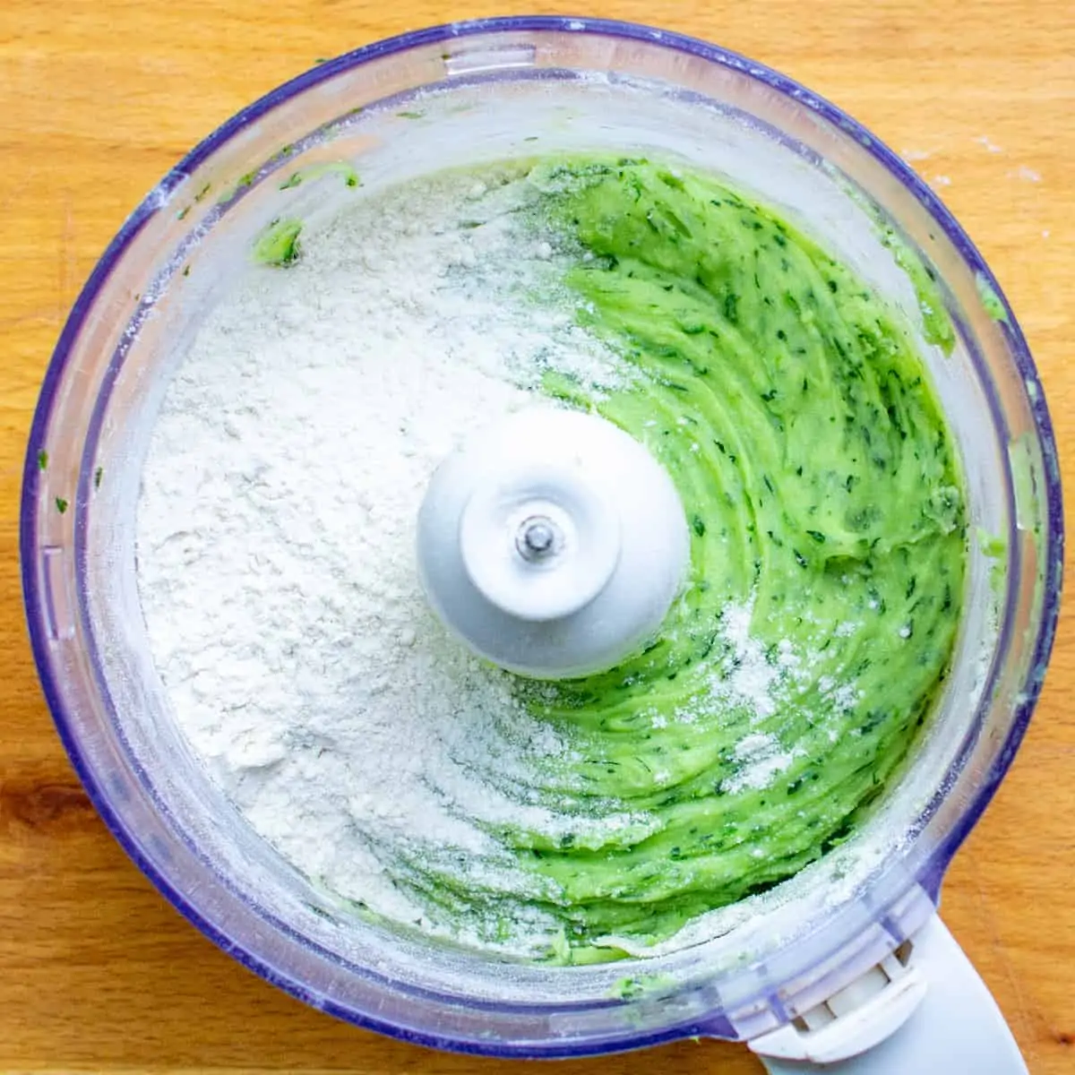 Adding the flour to make the gnocchi dough.