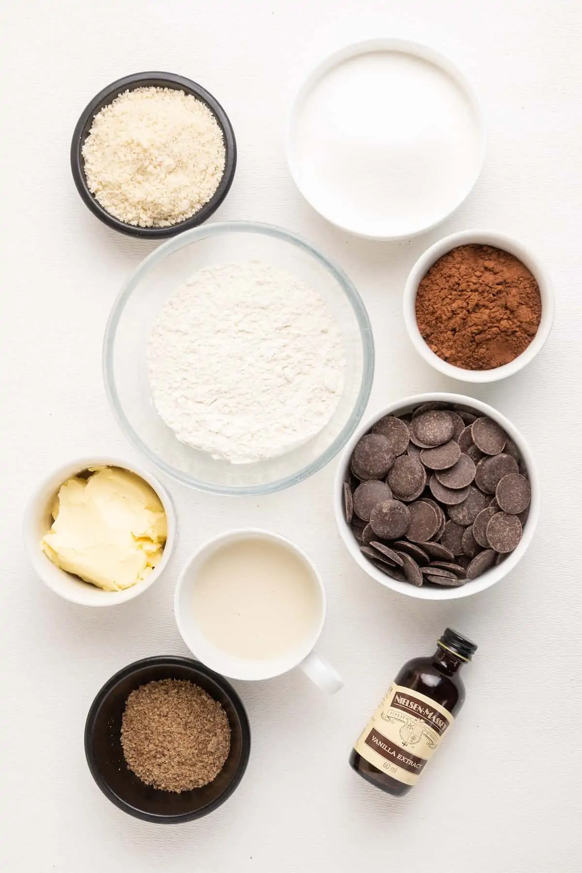The ingredients for a vegan chocolate brownie on a white background.