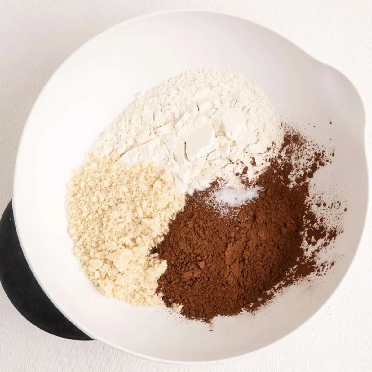 Flour, slat, ground almonds and cocoa powder in a mixing bowl.