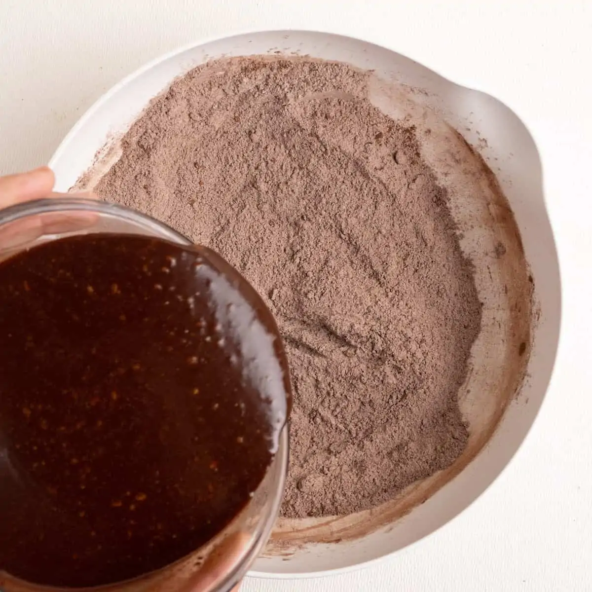 Mixing the wet and dry ingredients to make the brownie batter.