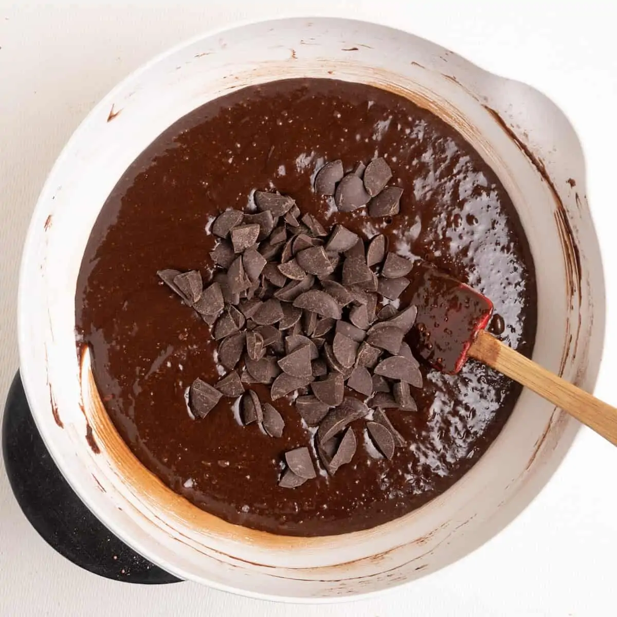 Stirring in chocolate chips to the vegan brownie batter.