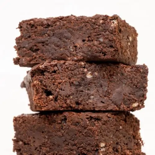 A stack of vegan chocolate brownies seen from the side.