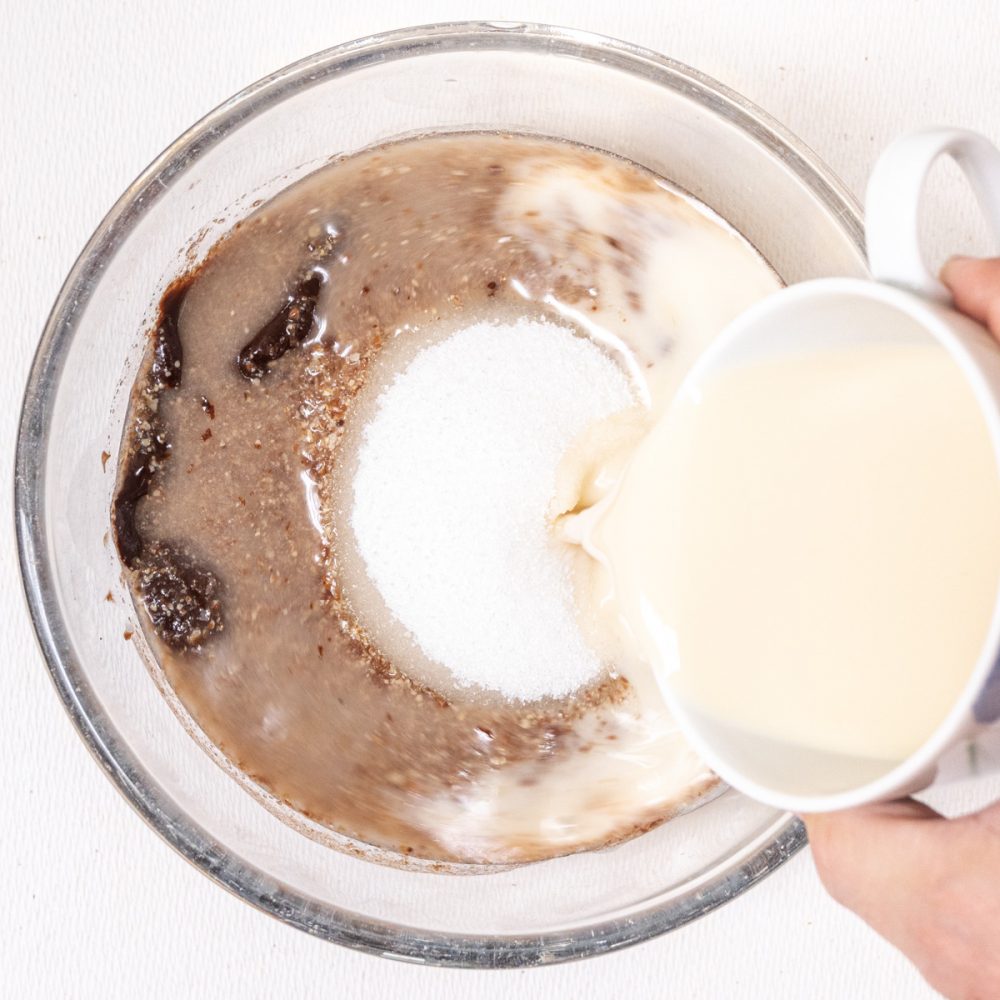 Melted chocolate is combined with sugar, flax egg, vanilla extract and oat milk.