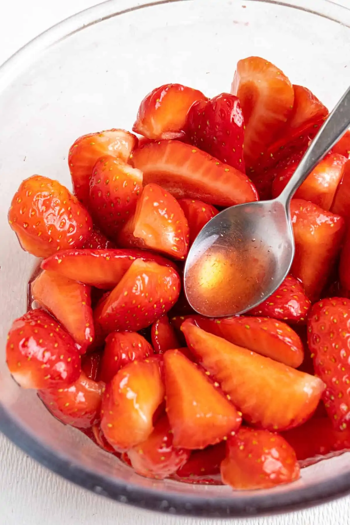 Strawberries in a bowl after being macerated to become soft and juicy.