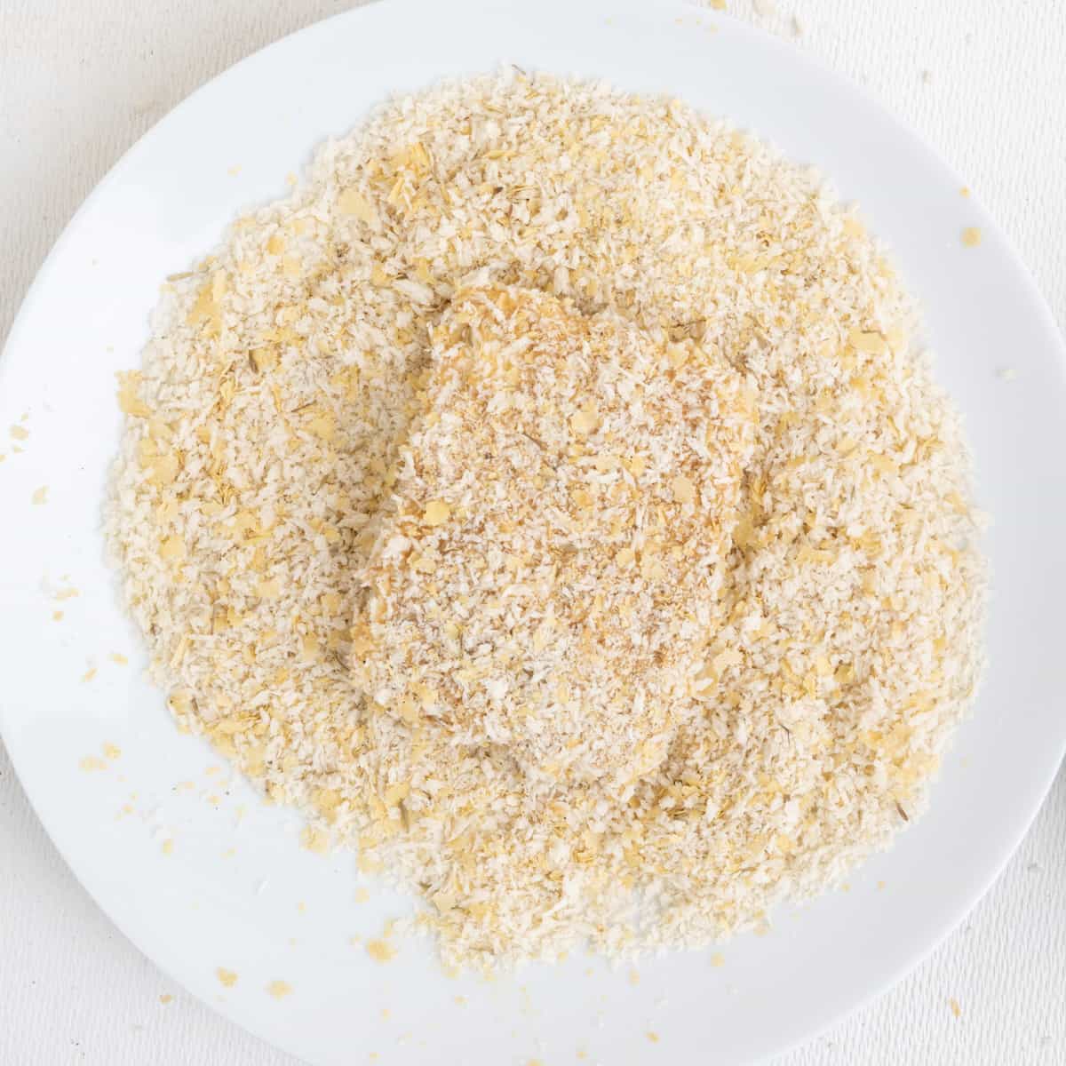 A recuangular slice of tofu completely covered in breadcrumbs.