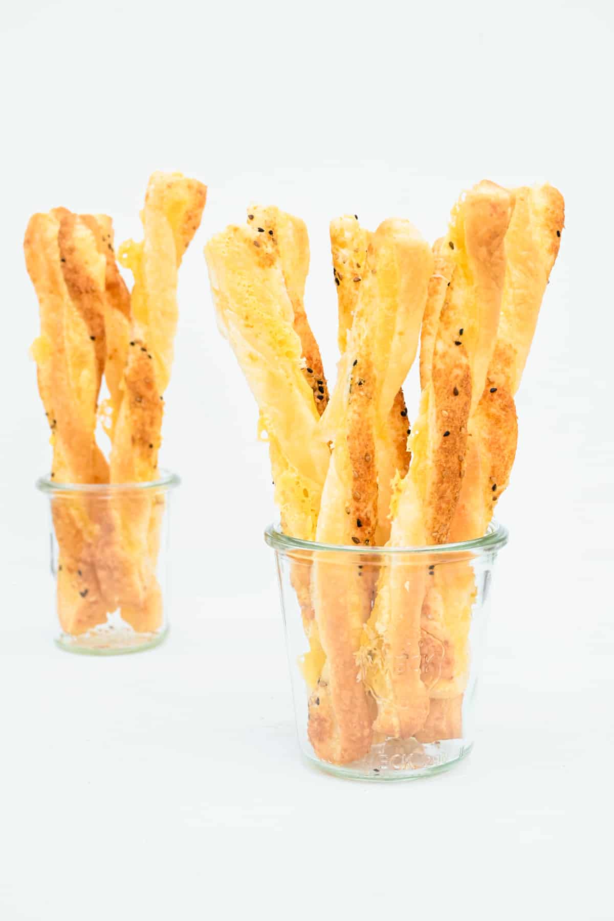 Cheese straws served in glasses are perfect for socials and parties.