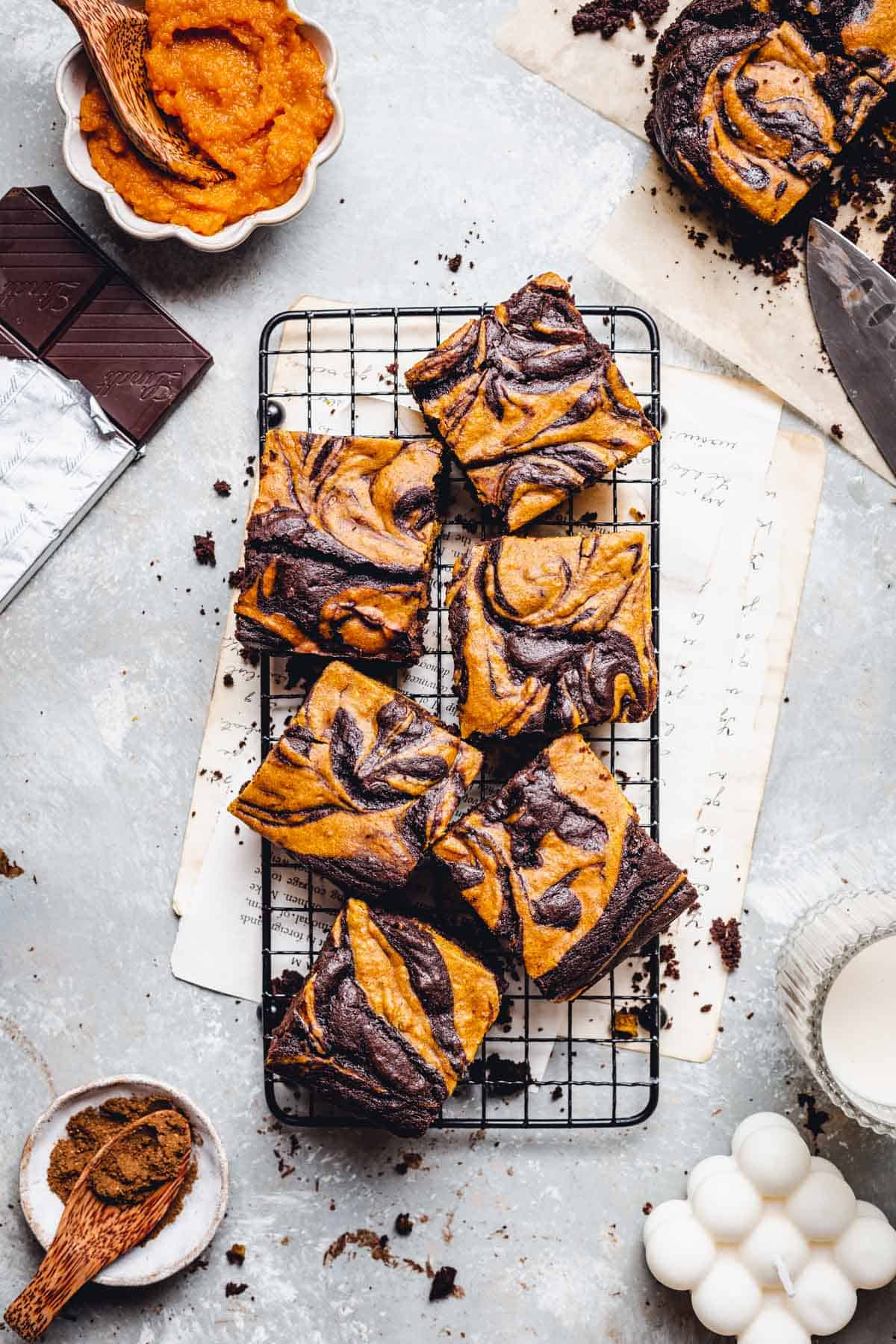 Pieces of vegan pumpkin and chooocolate brownie on a cooling rack.