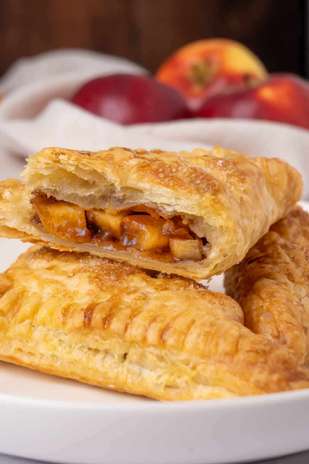 A turnover sliced open to reveal the moist and soft apple filling.