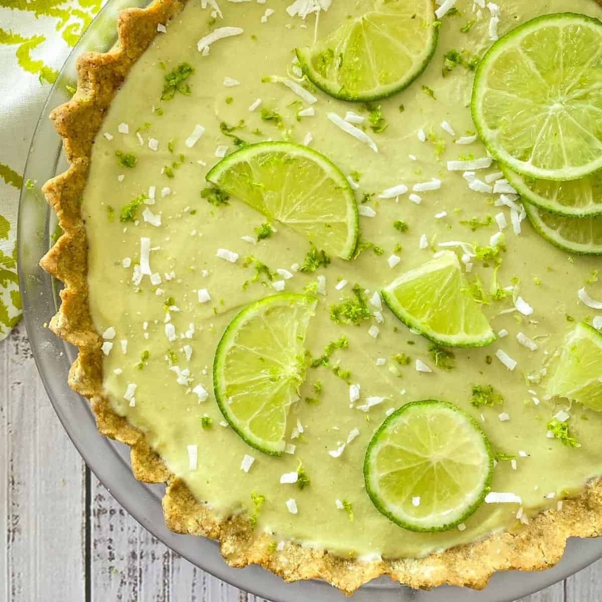 A vegan key lime pie topped with lime slices.