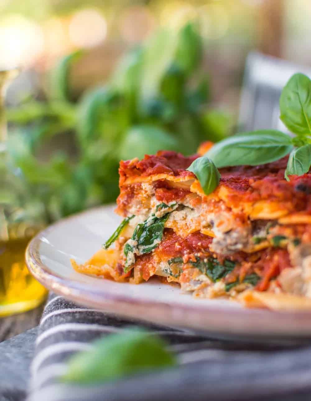 A slice of lasagna on a plate.