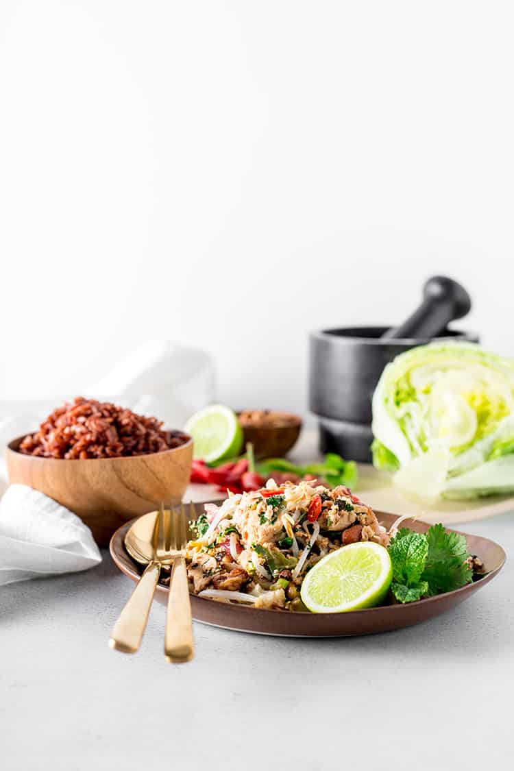 A dish of tofu larb garnished with lime.