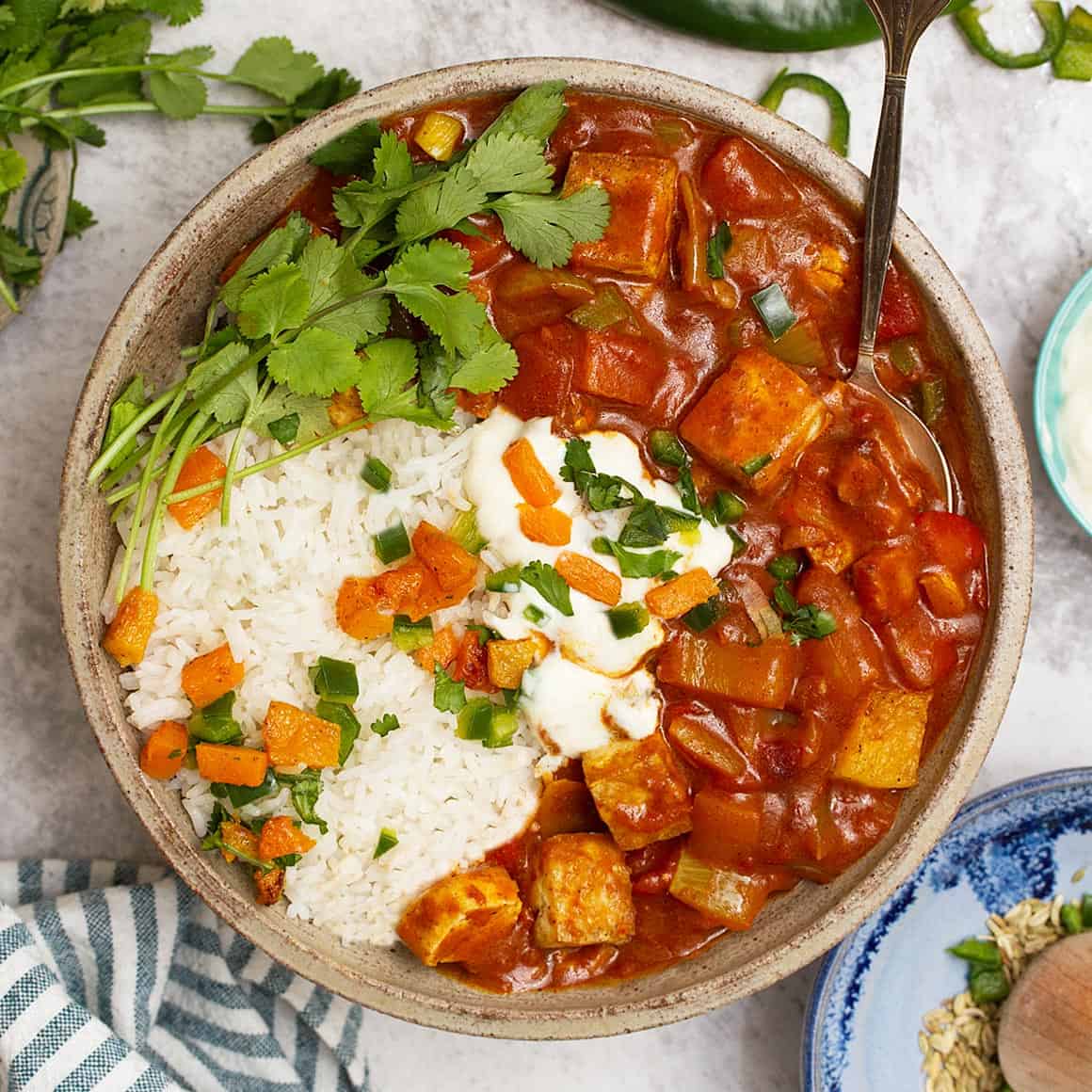Tofu jalfrezi with rice in a bowl. 