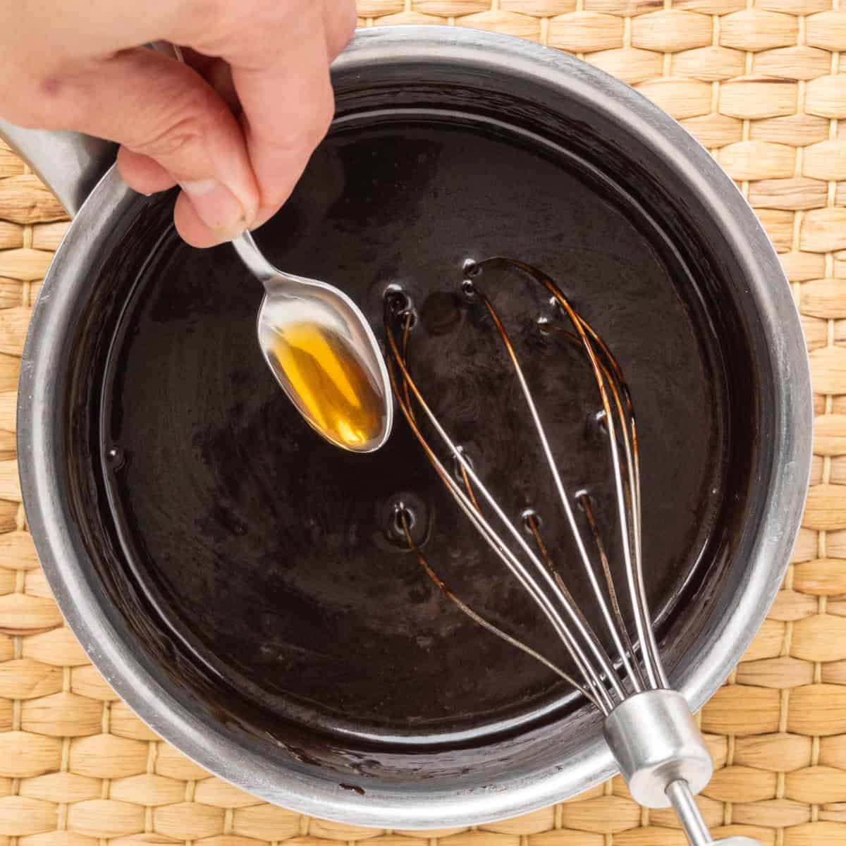 A small spoonful of vanilla extract is whisked into the sauce.