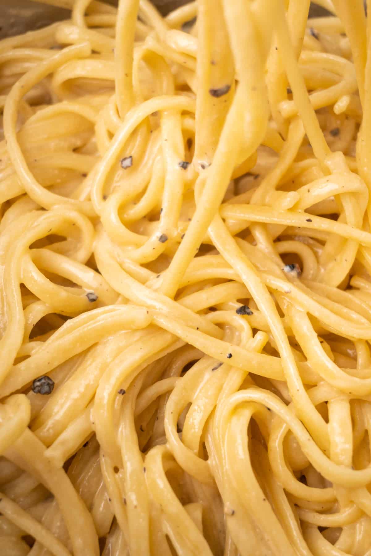 The glossy tahini sauce clings to and coats the linguine pasta.