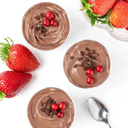 Creamy tofu chocolate mousse garnished with chocolate shaving and berries.