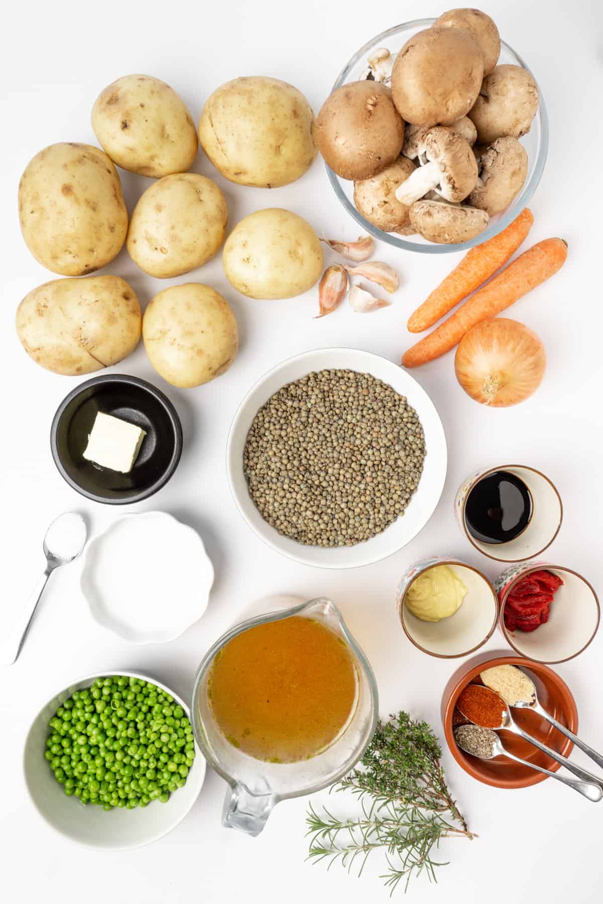 Vegetables, lentils, herbs and other ingredients needed for lentil shepherds pie.