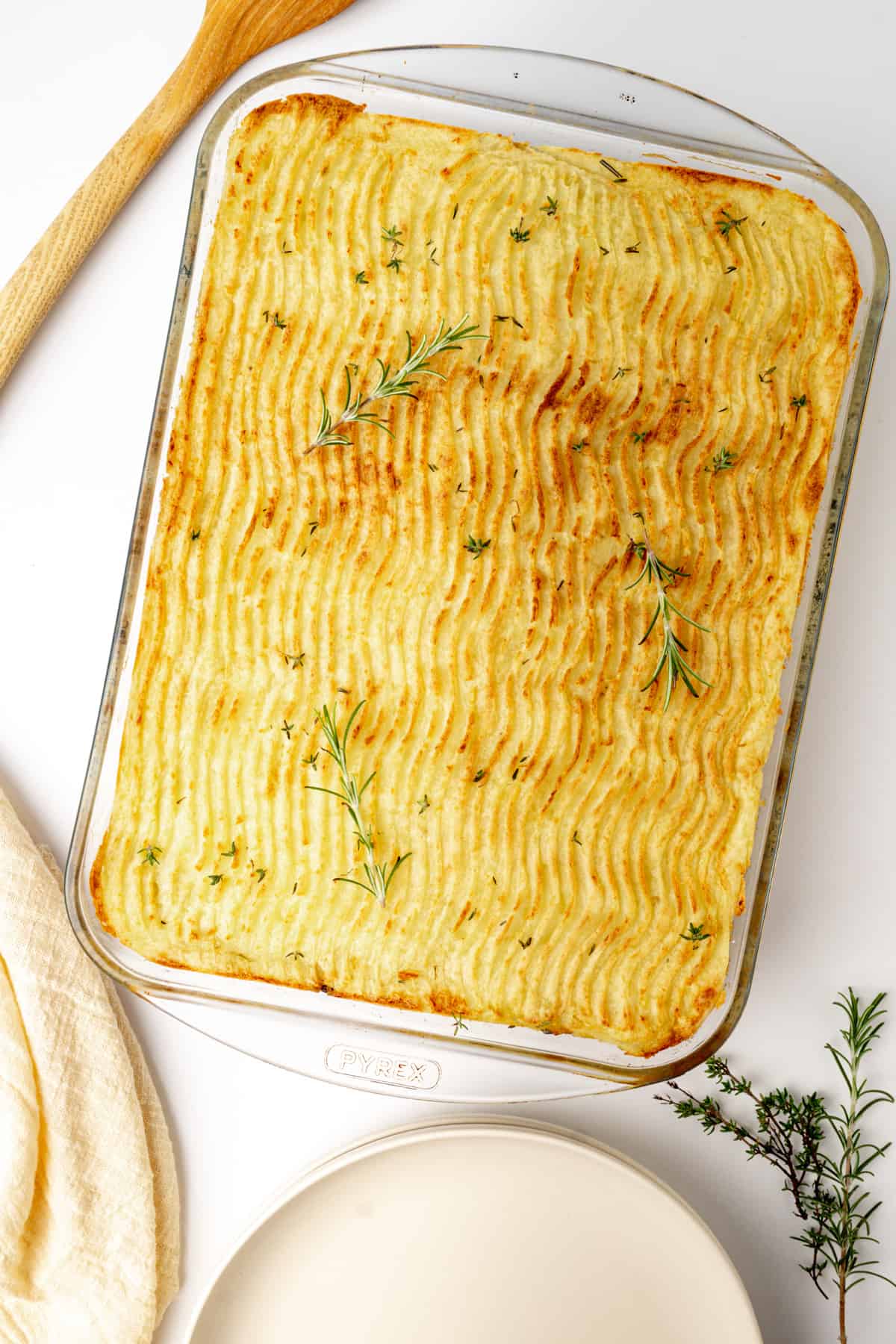 A baked shepherds pie in a glass oven dish.