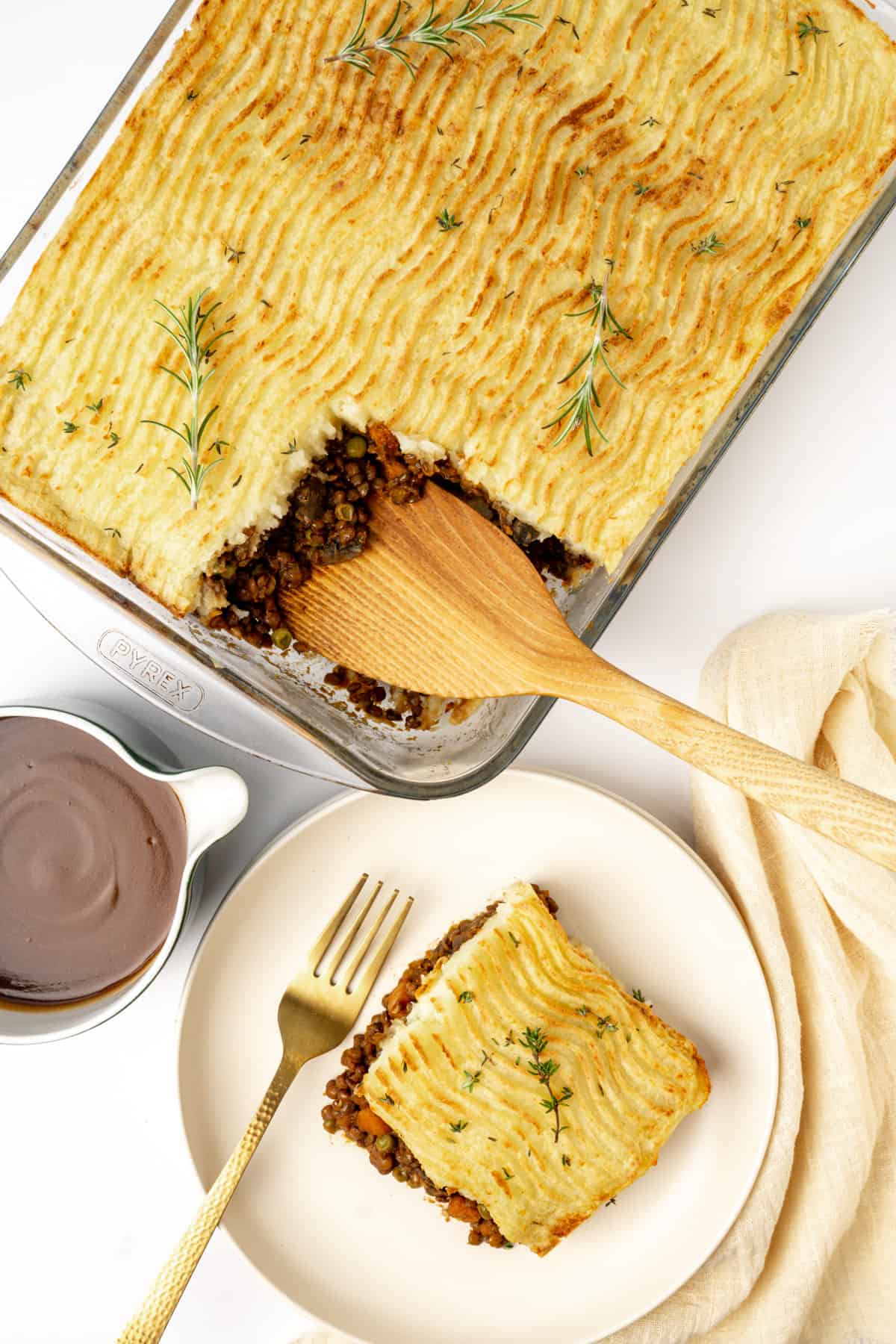 A shepherds pie in an oven dish and a slice of it on a plate.