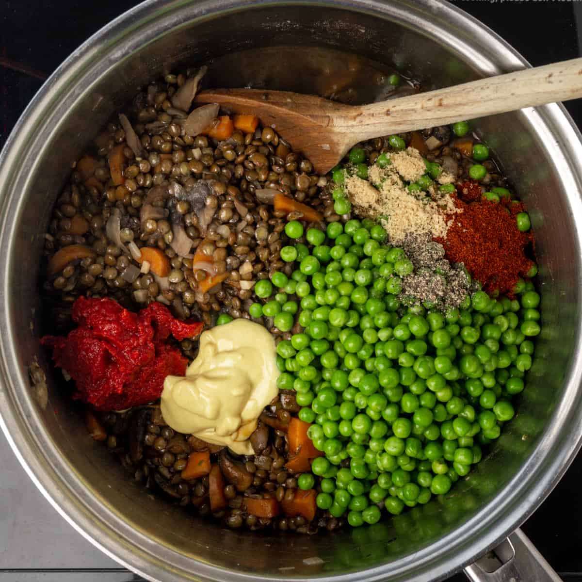 Peas, mustard, tomato puree, smoked paprika, and brown sugar stirred into to the lentil and vegetable filling.