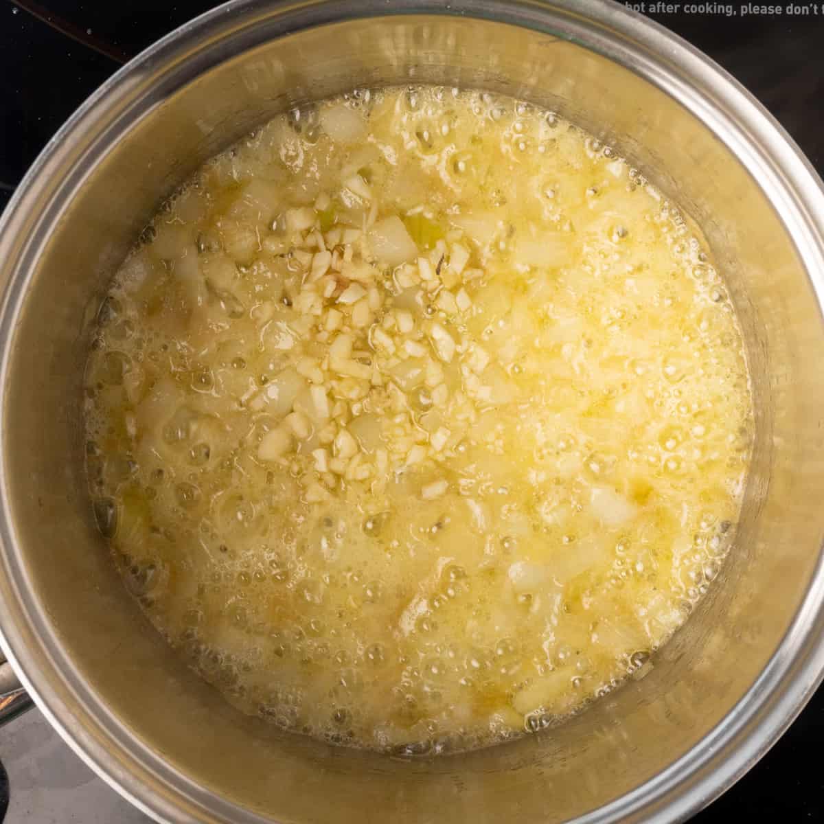 Diced onion and garlic sauteing in melted vegan butter.