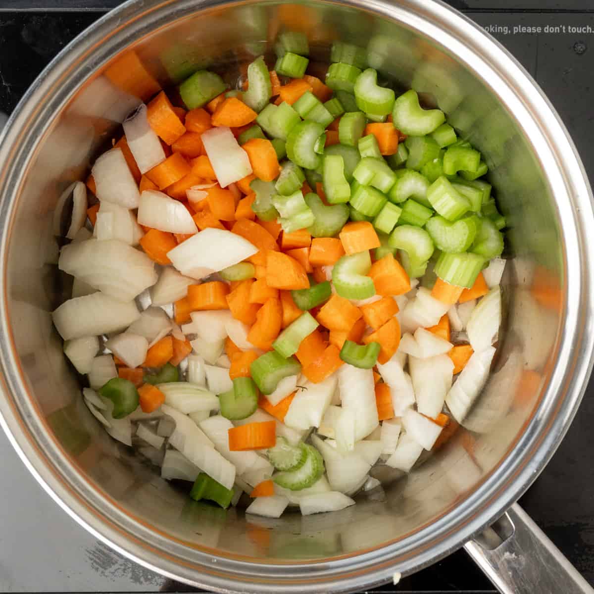 diced onion, carrot and celery in a saucepan.