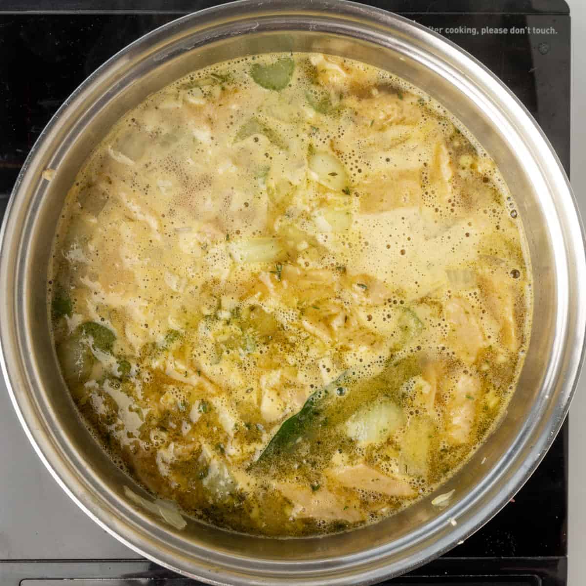 A broth simmering in a saucepan.